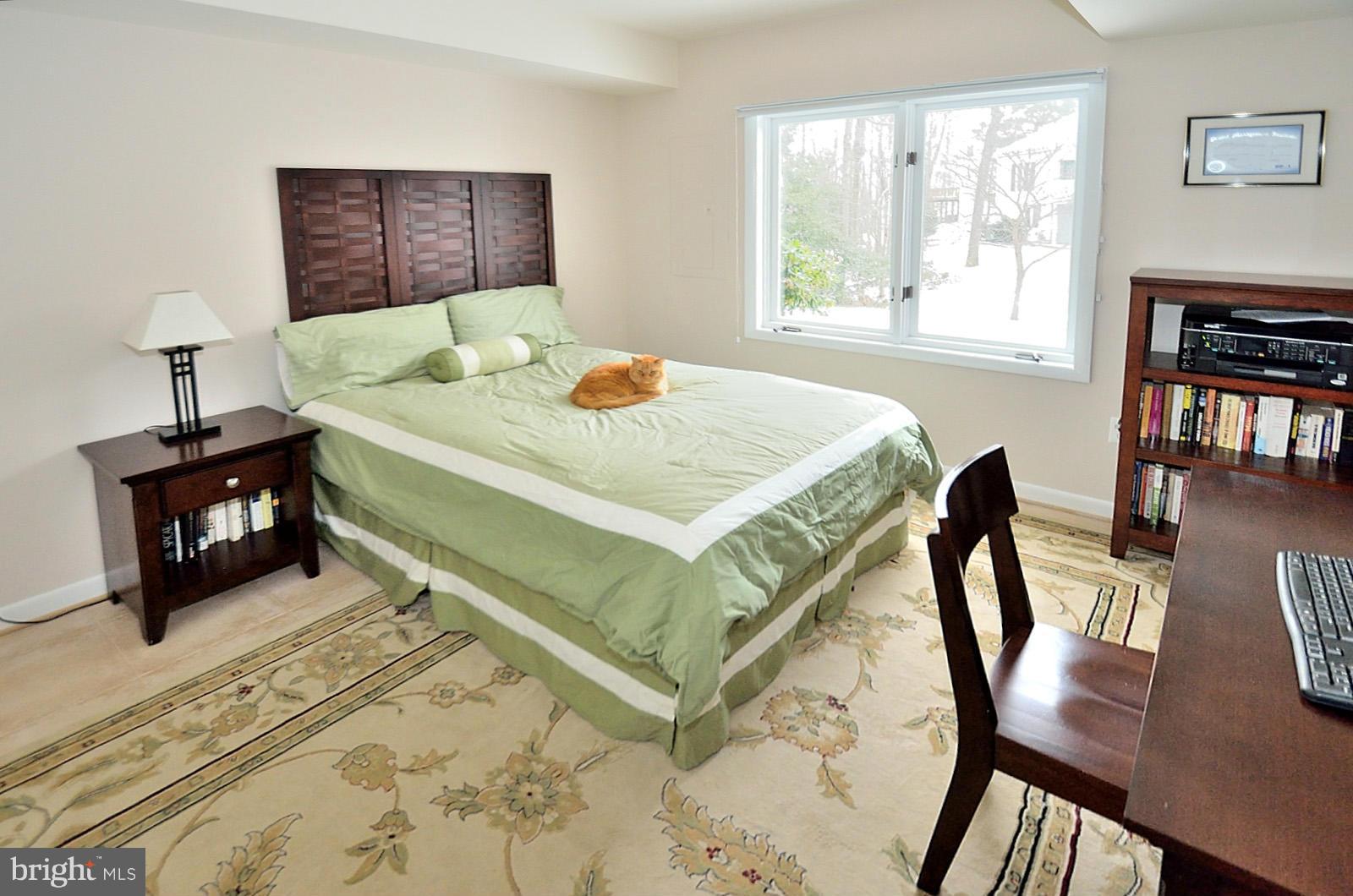 1283 Wedgewood Manor Way Reston, VA 20194 - Photo 19 of 27 a bedroom with a bed a table and chair with the floor