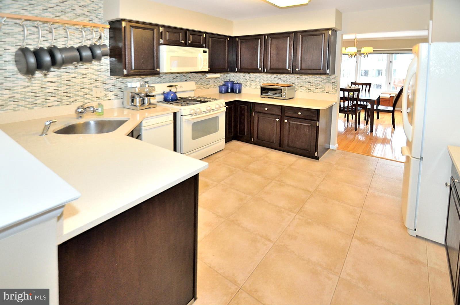 1283 Wedgewood Manor Way Reston, VA 20194 - Photo 4 of 27 a kitchen with a sink appliances and cabinets