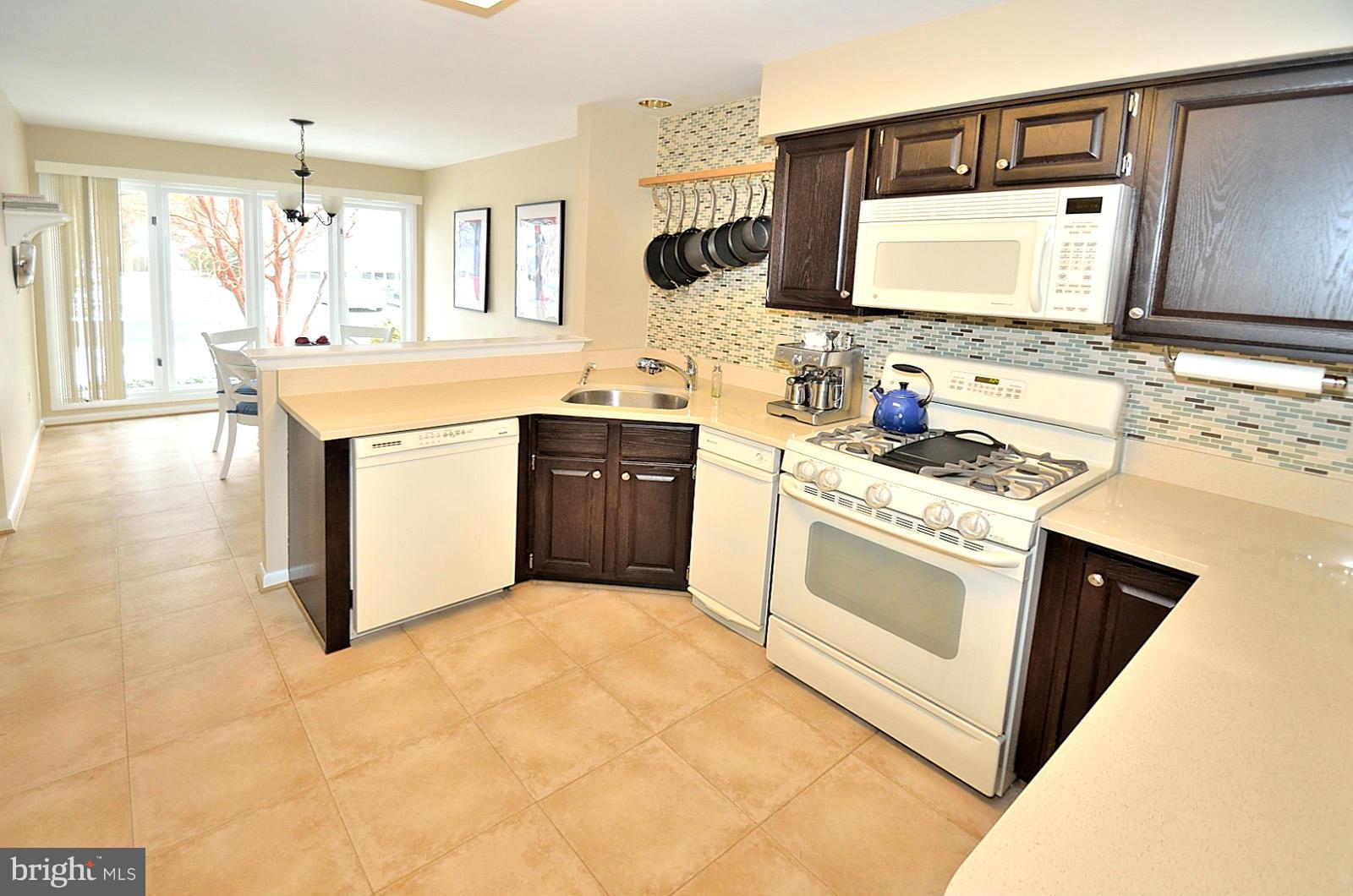 1283 Wedgewood Manor Way Reston, VA 20194 - Photo 5 of 27 a kitchen with stainless steel appliances granite countertop a sink stove and cabinets