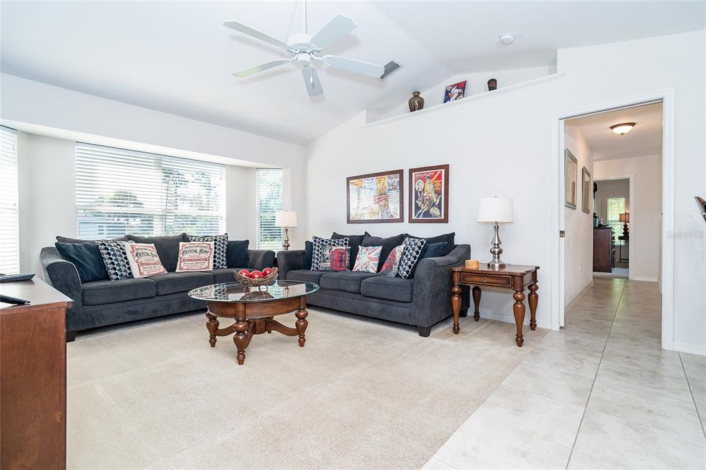 70 Tournament Road Rotonda West, FL 33947 - Photo 14 of 47 a living room with furniture and a large window