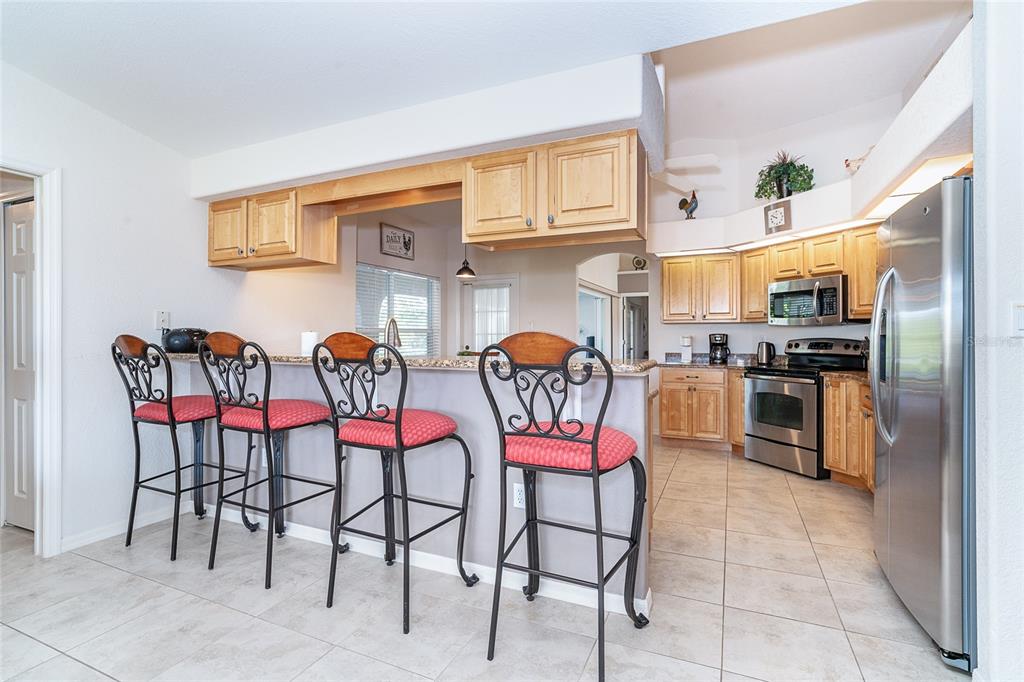70 Tournament Road Rotonda West, FL 33947 - Photo 15 of 47 a group of chairs sitting in a kitchen next to a window