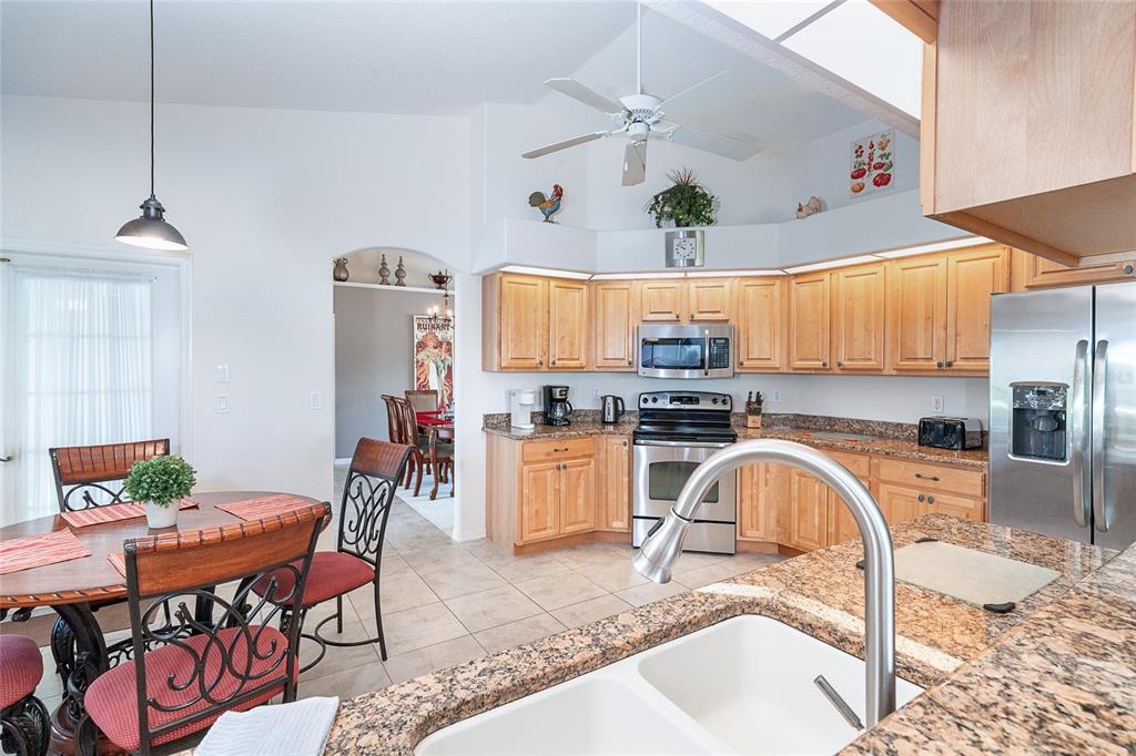 70 Tournament Road Rotonda West, FL 33947 - Photo 16 of 47 a living room with dining room and kitchen view