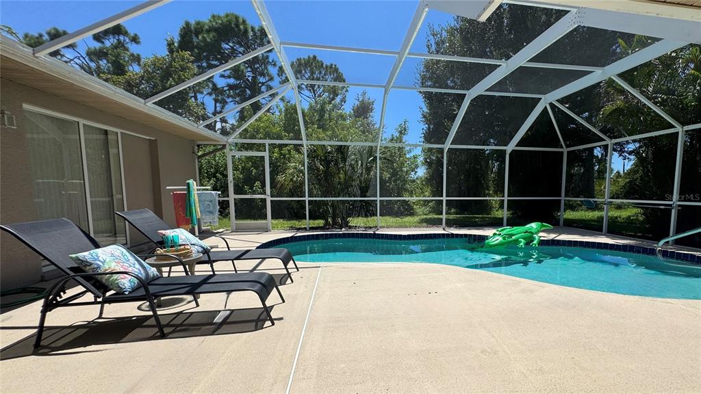 70 Tournament Road Rotonda West, FL 33947 - Photo 23 of 47 a view of a backyard with sitting area and porch