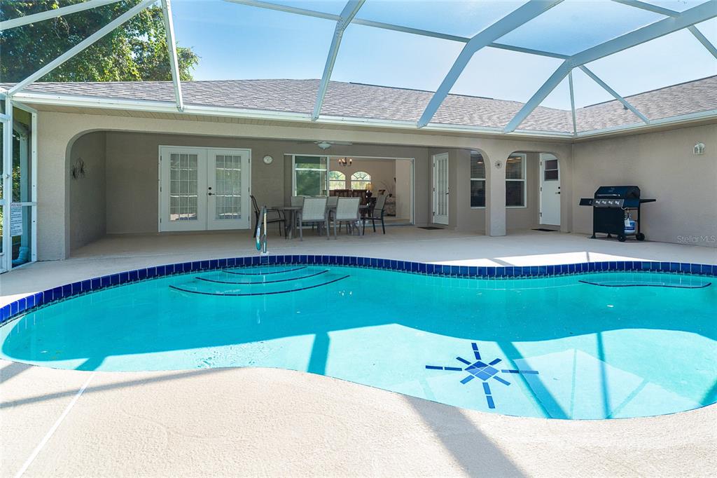 70 Tournament Road Rotonda West, FL 33947 - Photo 27 of 47 a view of a white house with a swimming pool