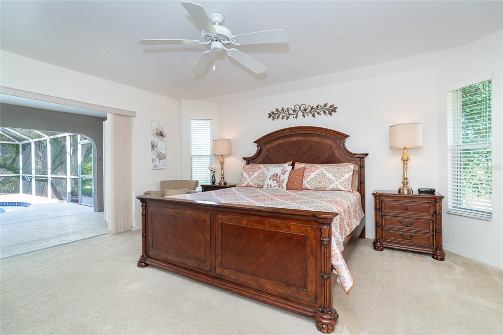 70 Tournament Road Rotonda West, FL 33947 - Photo 29 of 47 a bedroom with a bed and a large window