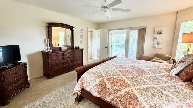 a spacious bedroom with a bed and a flat screen tv