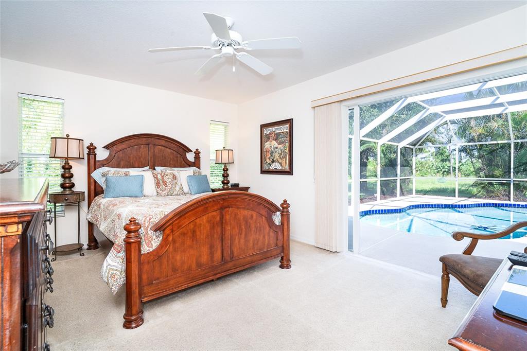 70 Tournament Road Rotonda West, FL 33947 - Photo 35 of 47 a spacious bedroom with a bed and window