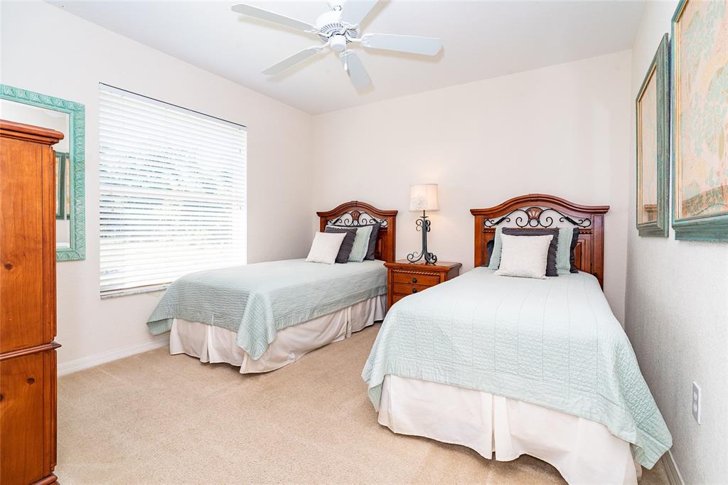 70 Tournament Road Rotonda West, FL 33947 - Photo 39 of 47 a spacious bedroom with two bed and a window