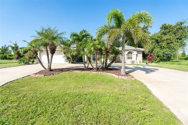 a view of a swimming pool with a house and a yard