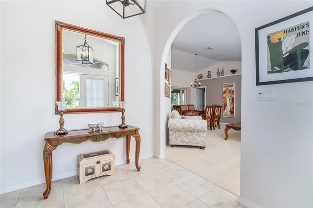 a bedroom with furniture and a mirror