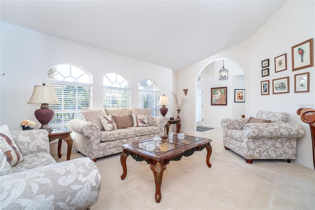 70 Tournament Road Rotonda West, FL 33947 - Photo 9 of 47 a living room with furniture and a large window