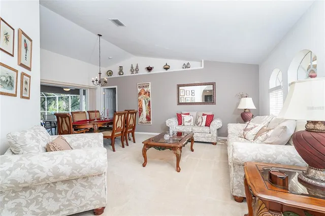 a living room with furniture and a chandelier