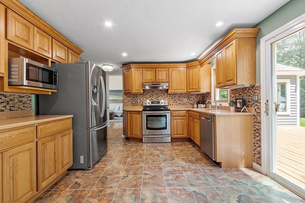 5 Thicket Circle Stow, MA 01775 - Photo 13 of 37 a kitchen with stainless steel appliances granite countertop a refrigerator a stove and a sink