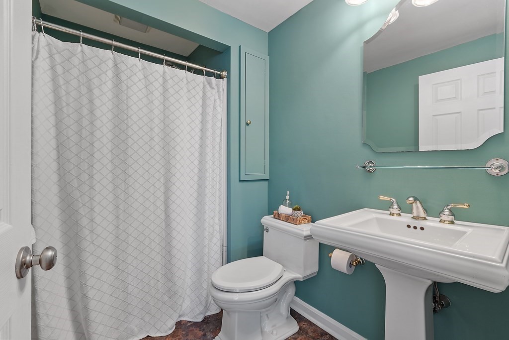 5 Thicket Circle Stow, MA 01775 - Photo 27 of 37 a bathroom with a sink a toilet and a mirror