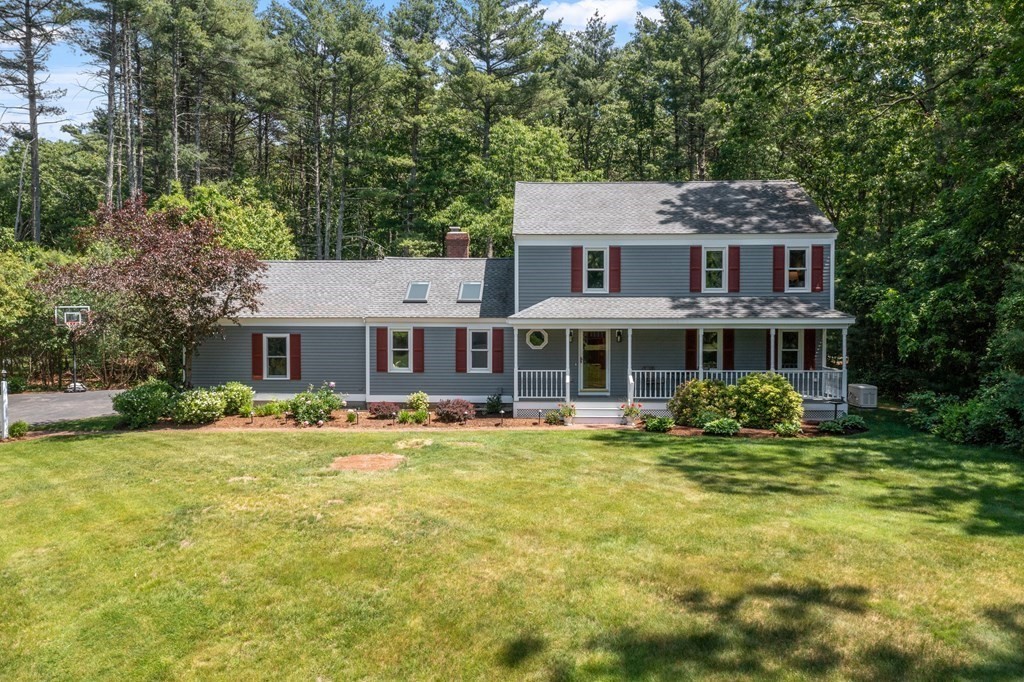 5 Thicket Circle Stow, MA 01775 - Photo 29 of 37 a front view of a house with a yard table and chairs