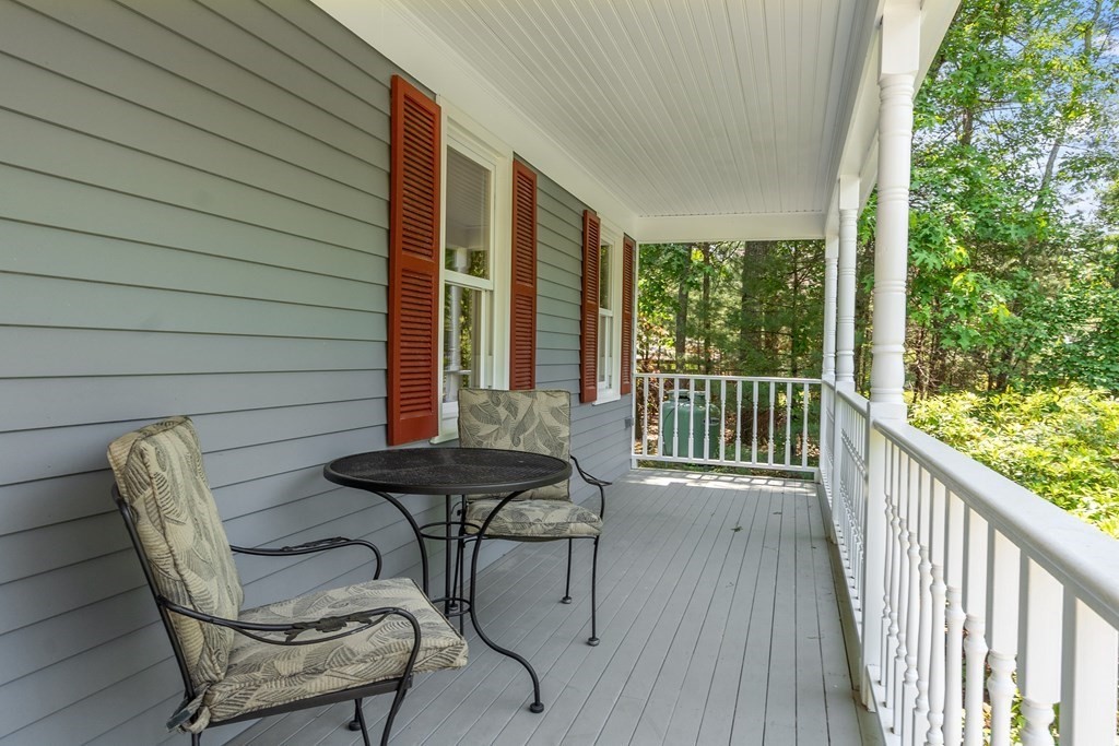 5 Thicket Circle Stow, MA 01775 - Photo 4 of 37 a view of a balcony with furniture and wooden floor