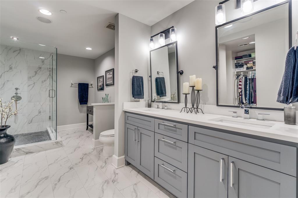 1505 Elm Street, Unit 1504 Dallas, TX 75201 - Photo 17 of 33 Bathroom with a walk in closet, double vanity, a marble finish shower, light marble finish flooring, and recessed lighting