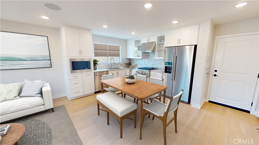 4357 Jasmine Lane Arcadia, CA 91006 - Photo 5 of 12 a kitchen with stainless steel appliances kitchen island granite countertop a refrigerator a stove a sink a dining table and chairs with wooden floor