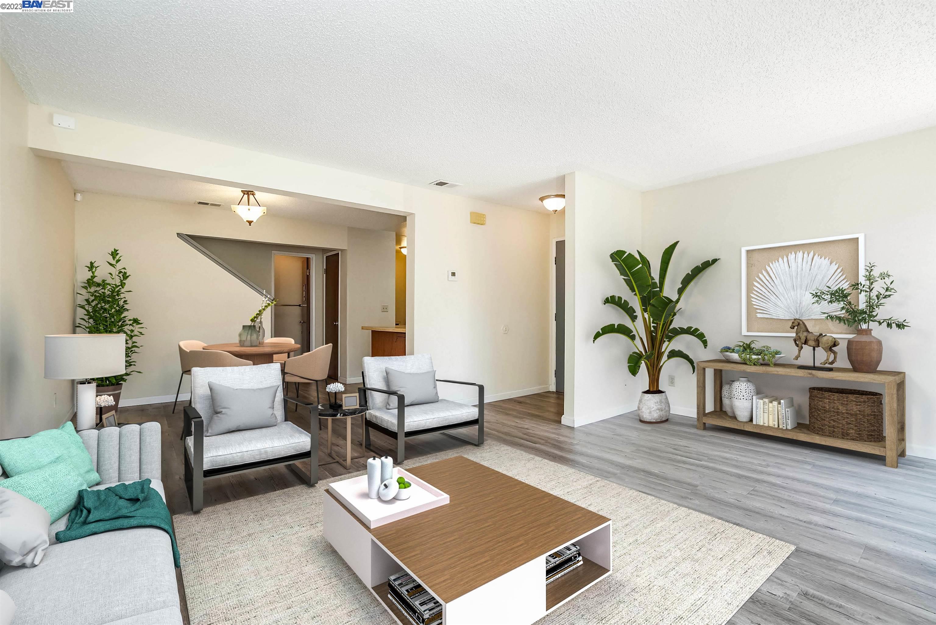 a living room with furniture rug and wooden floor