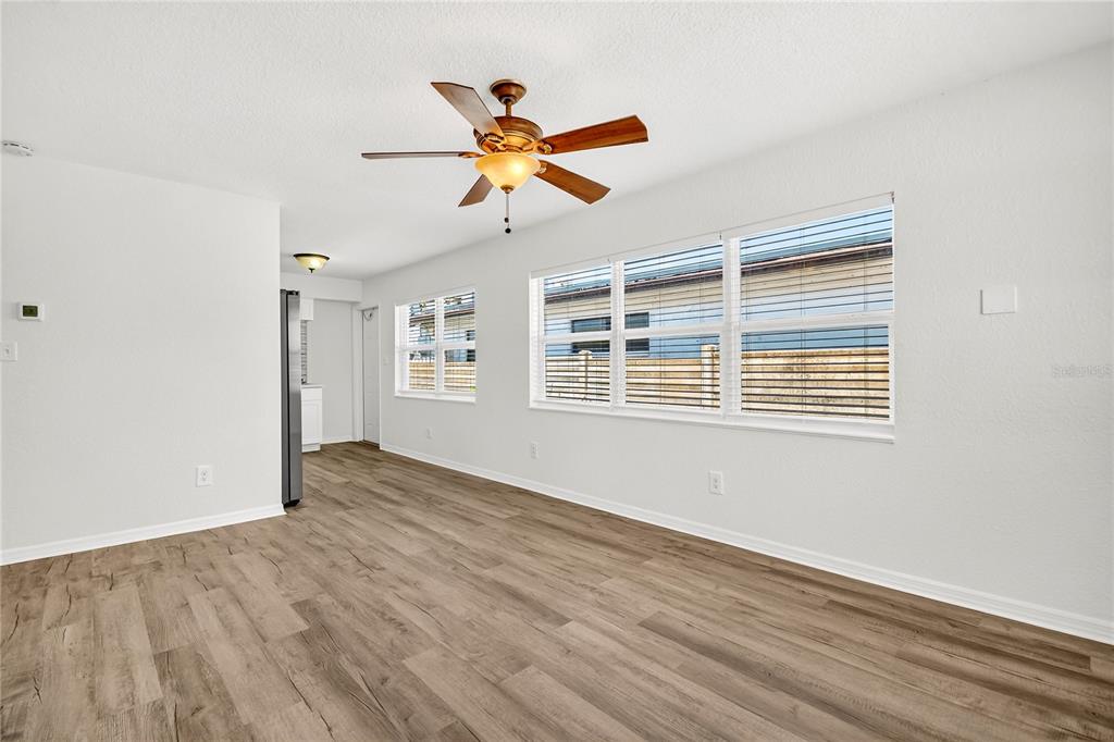 13440 1st Street East Madeira Beach, FL 33708 - Photo 32 of 44 a view of a room with wooden floor and windows