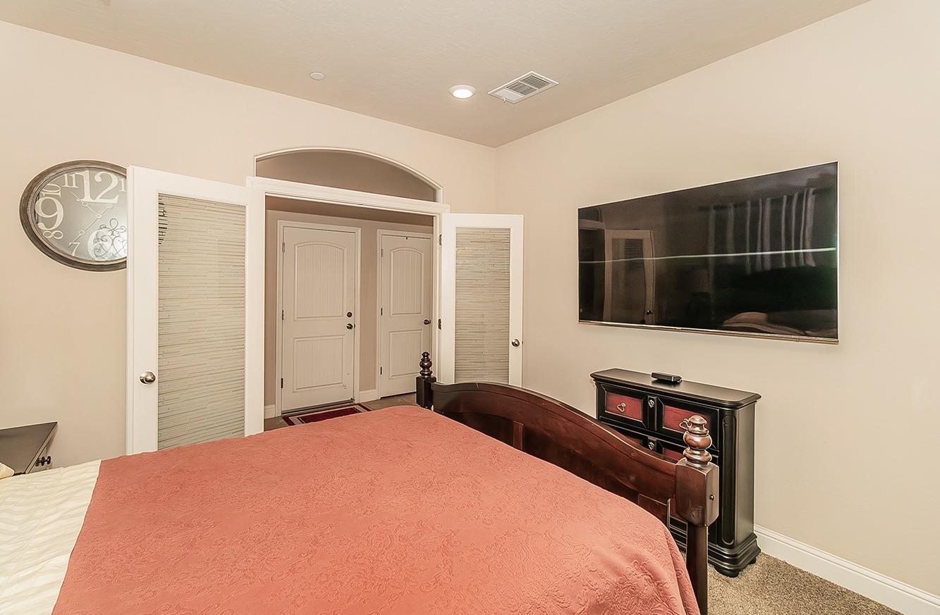 2043 North Soledad Avenue Clovis, CA 93619 - Photo 11 of 33 a bedroom with a bed and a television in it