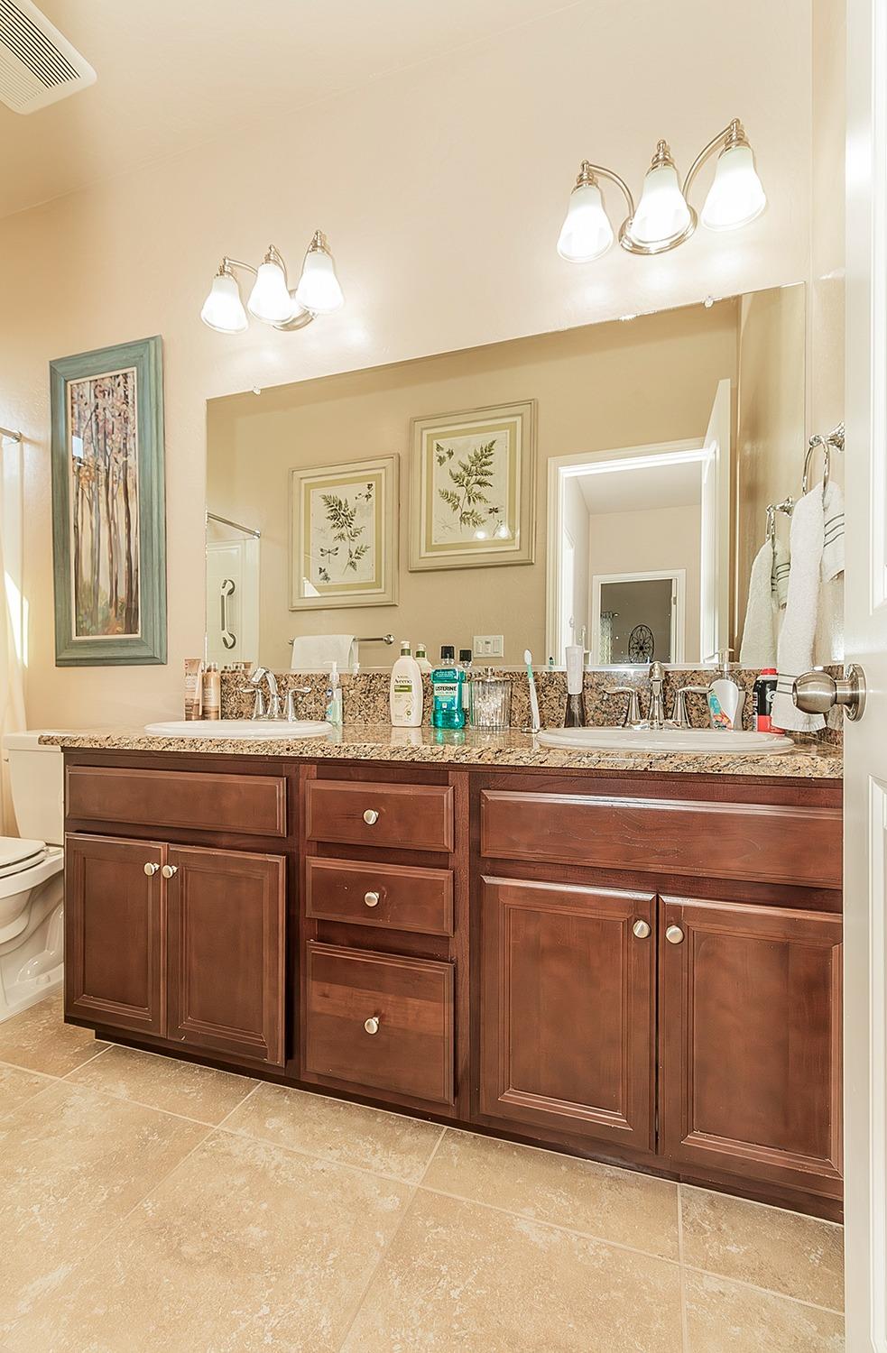2043 North Soledad Avenue Clovis, CA 93619 - Photo 22 of 33 a bathroom with a granite countertop double vanity sink and a mirror