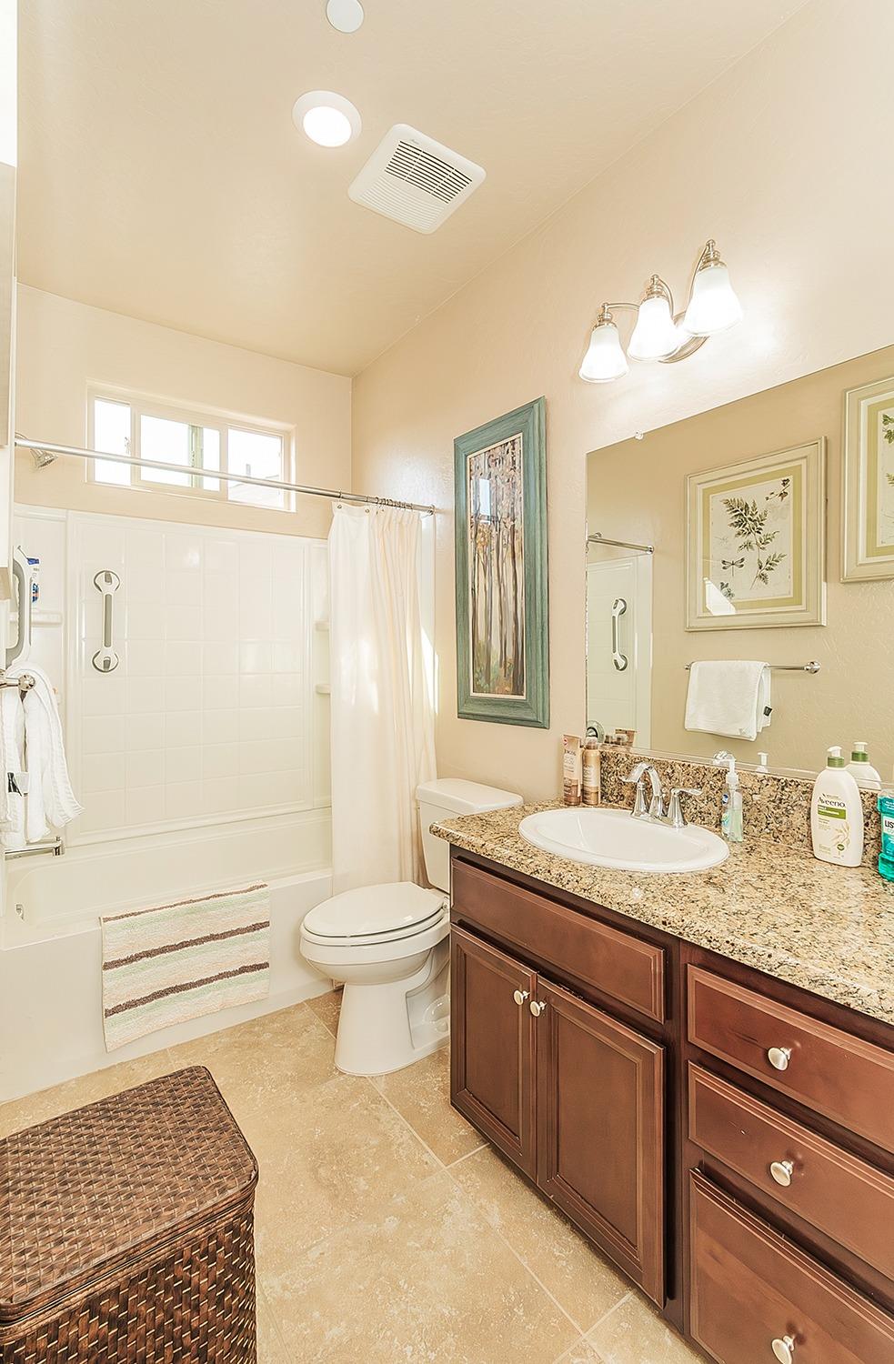 2043 North Soledad Avenue Clovis, CA 93619 - Photo 23 of 33 a bathroom with a granite countertop toilet sink and mirror