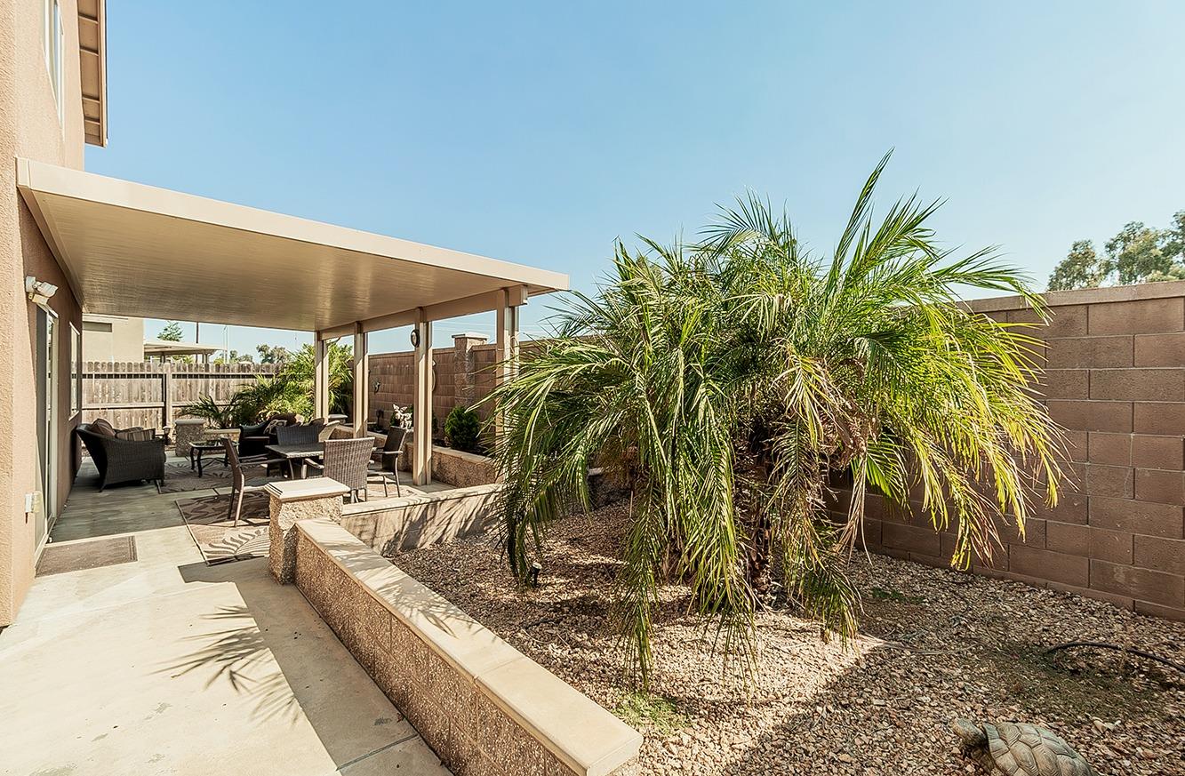 2043 North Soledad Avenue Clovis, CA 93619 - Photo 32 of 33 a view of a patio with a table and chairs under an umbrella