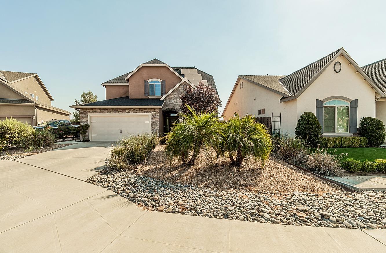 2043 North Soledad Avenue Clovis, CA 93619 - Photo 33 of 33 a view of a white house next to a yard and trees