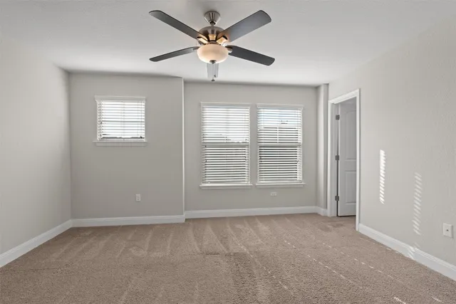 an empty room with a empty space and a ceiling fan