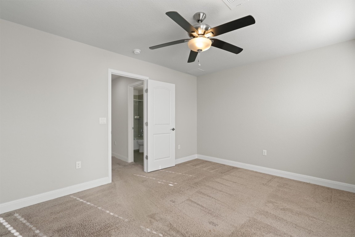 10502 Turnbull Loop, Unit 41 Austin, TX 78717 - Photo 22 of 29 Unfurnished bedroom with ceiling fan and light carpet
