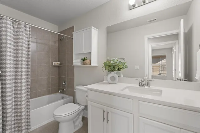 an empty room with closet and fan