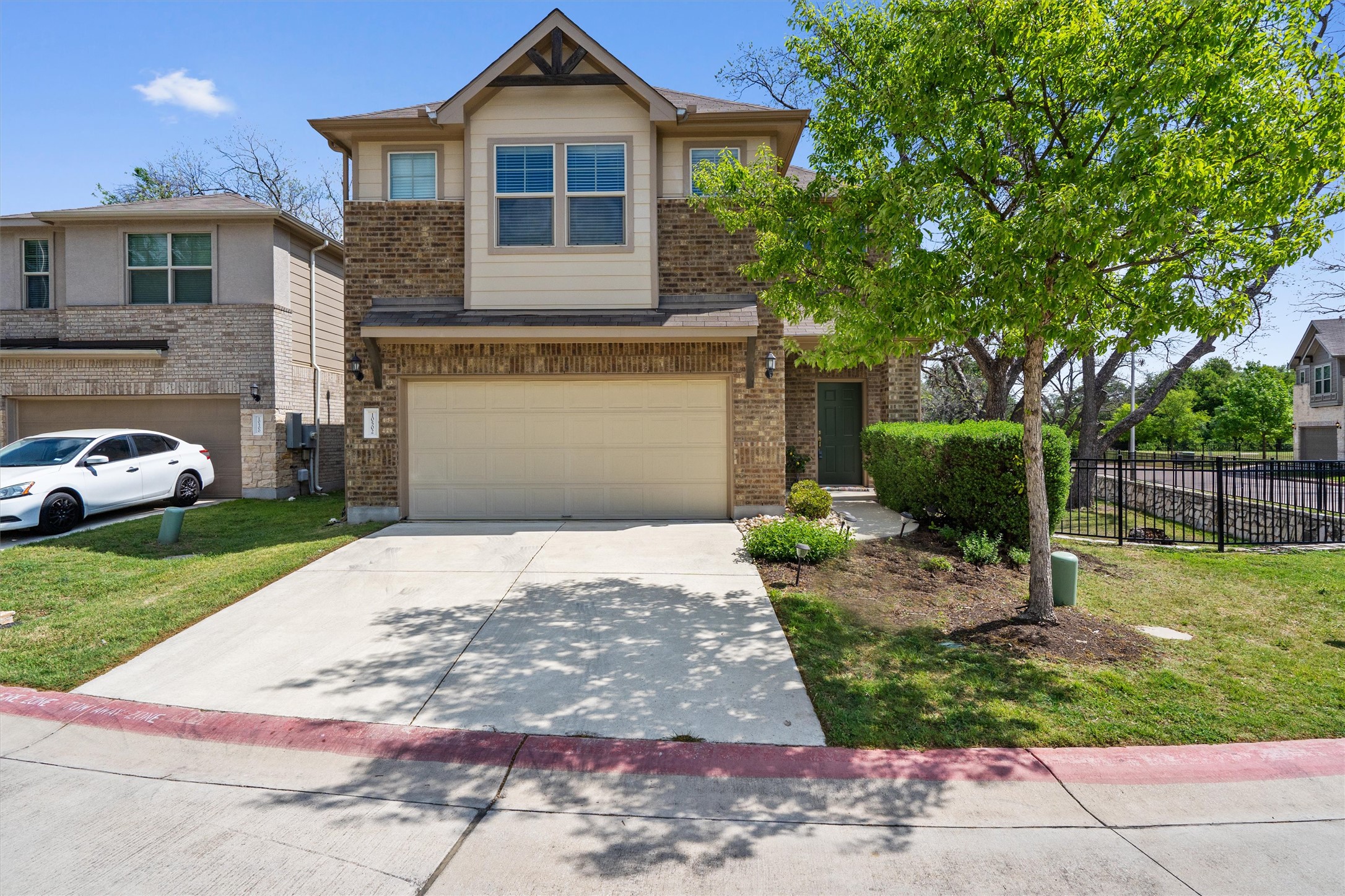 10502 Turnbull Loop, Unit 41 Austin, TX 78717 - Photo 28 of 35 View of front of home with concrete driveway, a garage, and brick siding