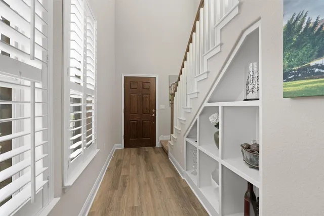 a view of entryway with wooden floor and stairs