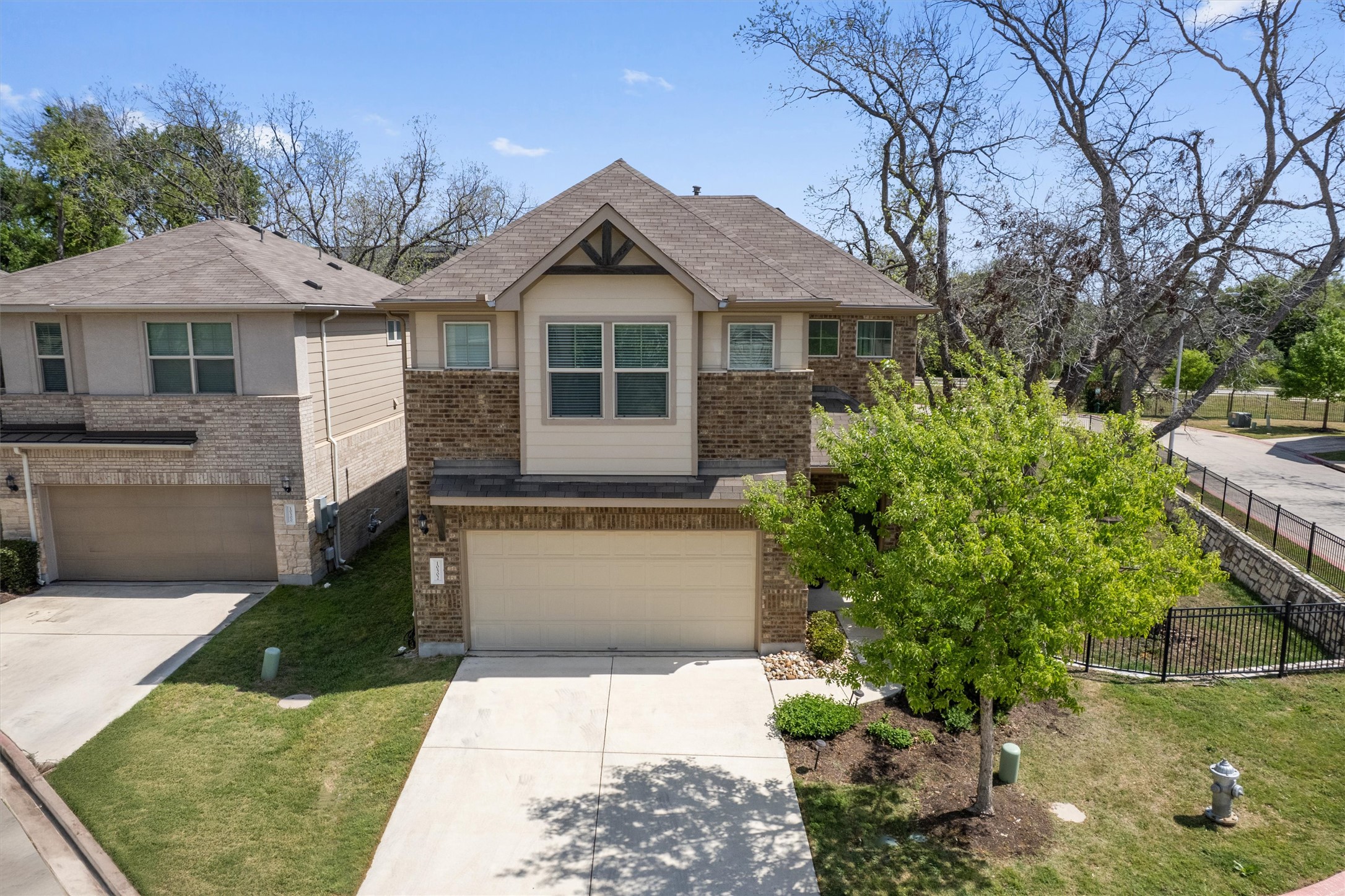 10502 Turnbull Loop, Unit 41 Austin, TX 78717 - Photo 30 of 35 Craftsman house featuring concrete driveway, brick siding, and a garage