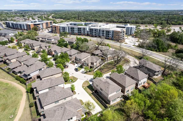 an aerial view of a house with a yard