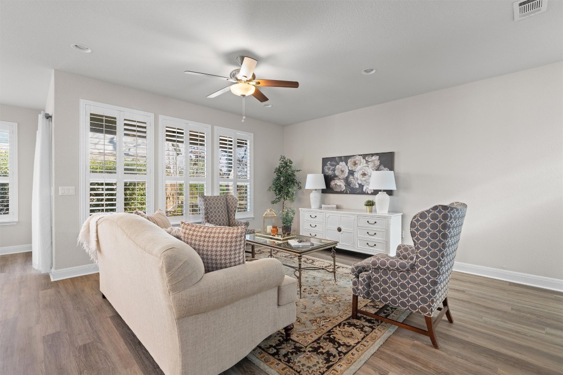 10502 Turnbull Loop, Unit 41 Austin, TX 78717 - Photo 5 of 29 Living room featuring a ceiling fan, LVP floors, shutters and recessed lighting