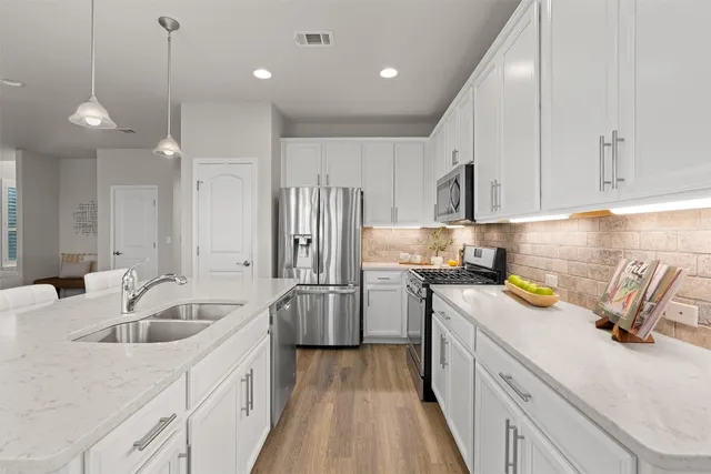a kitchen with refrigerator a sink and cabinets