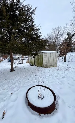 a view of a dry yard covered with snow