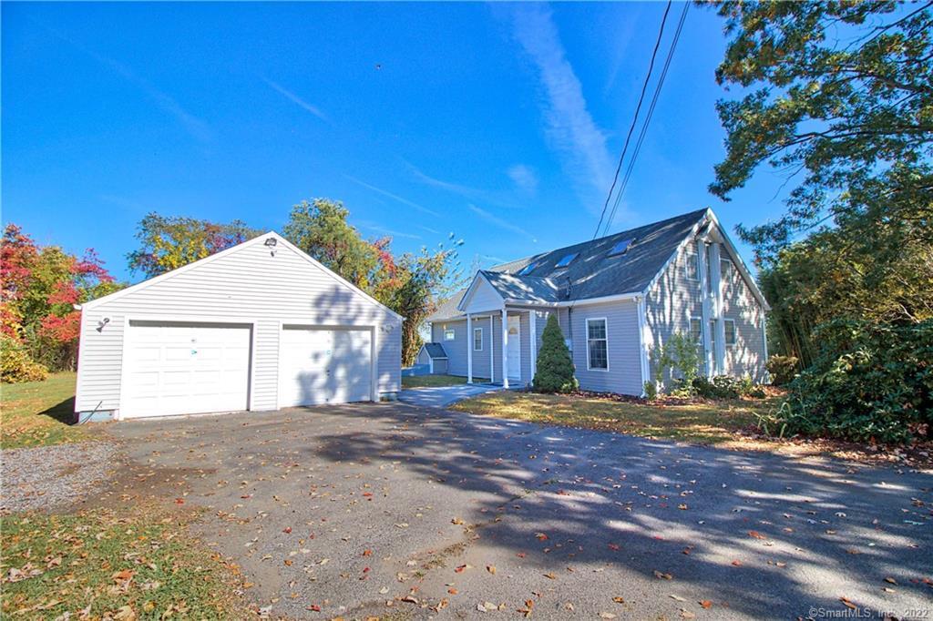 a view of large house with a yard and large tree
