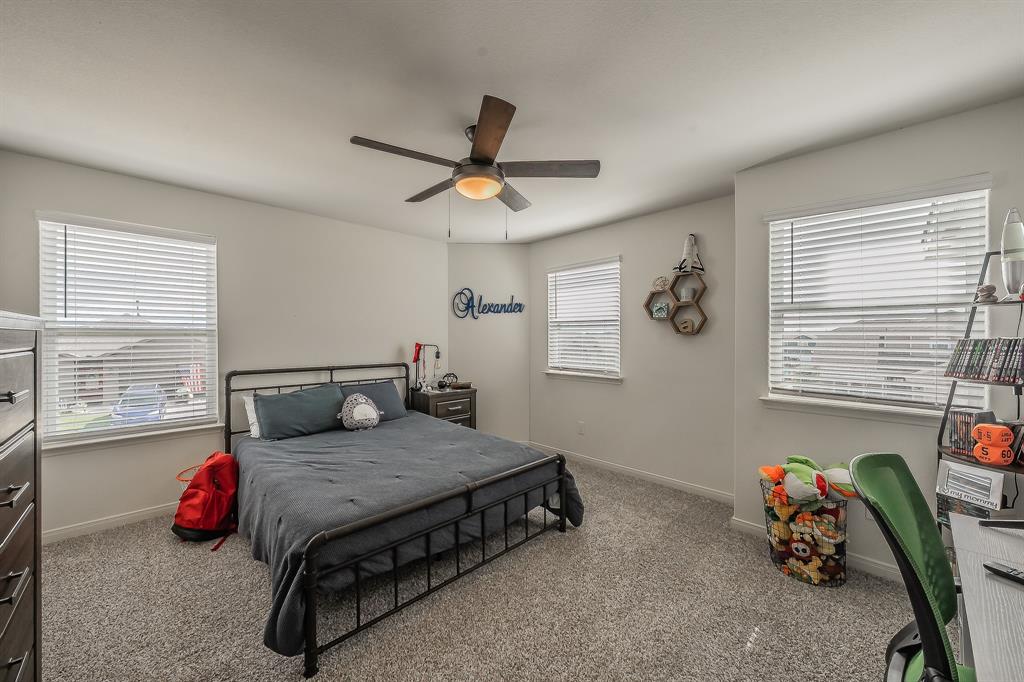 8125 White Sulphur Road Ponder, TX 76259 - Photo 25 of 38 Spacious room featuring carpeting, multiple windows with blinds, a ceiling fan with integrated lighting, and white painted walls