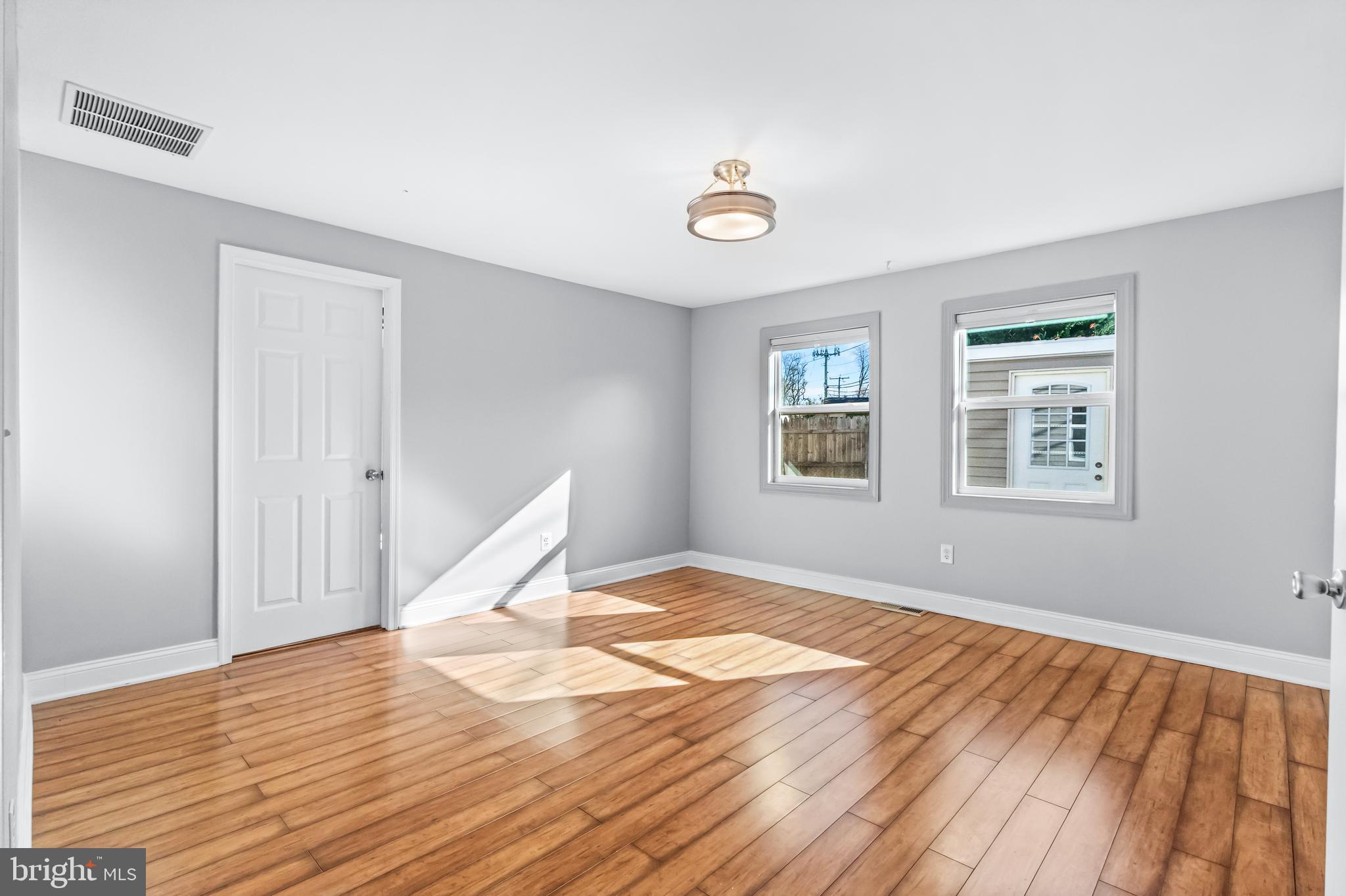 1000 8th Street Laurel, MD 20707 - Photo 14 of 45 a view of empty room with wooden floor and fan