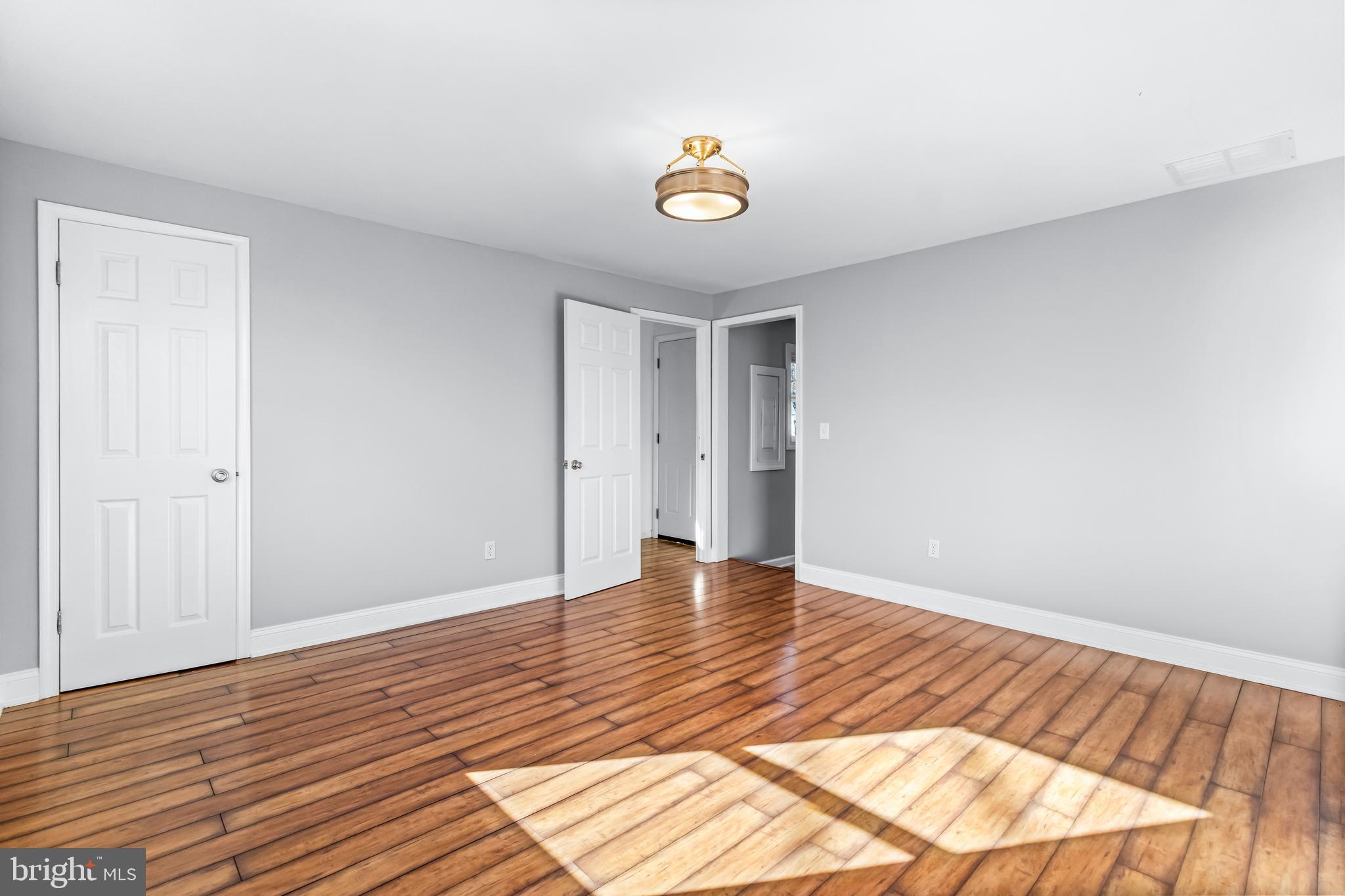 1000 8th Street Laurel, MD 20707 - Photo 16 of 45 a view of empty room with wooden floor and fan