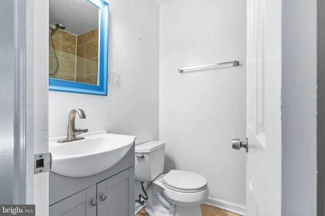 a bathroom with a sink mirror toilet and vanity