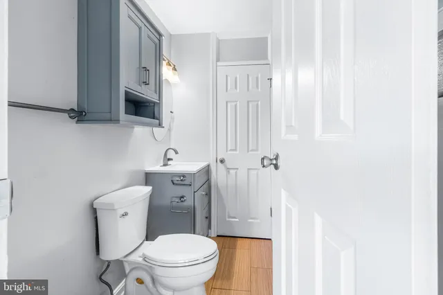 a white toilet sitting next to a bathroom sink
