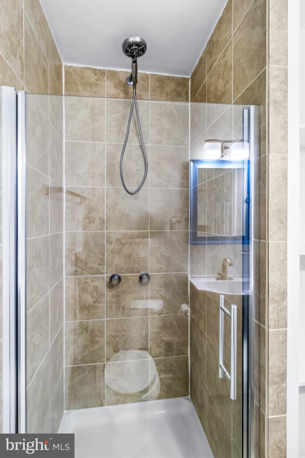 1000 8th Street Laurel, MD 20707 - Photo 23 of 45 a bathroom with a shower and a sink