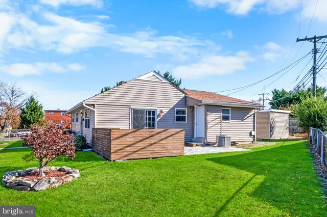 a front view of a house with a garden and yard