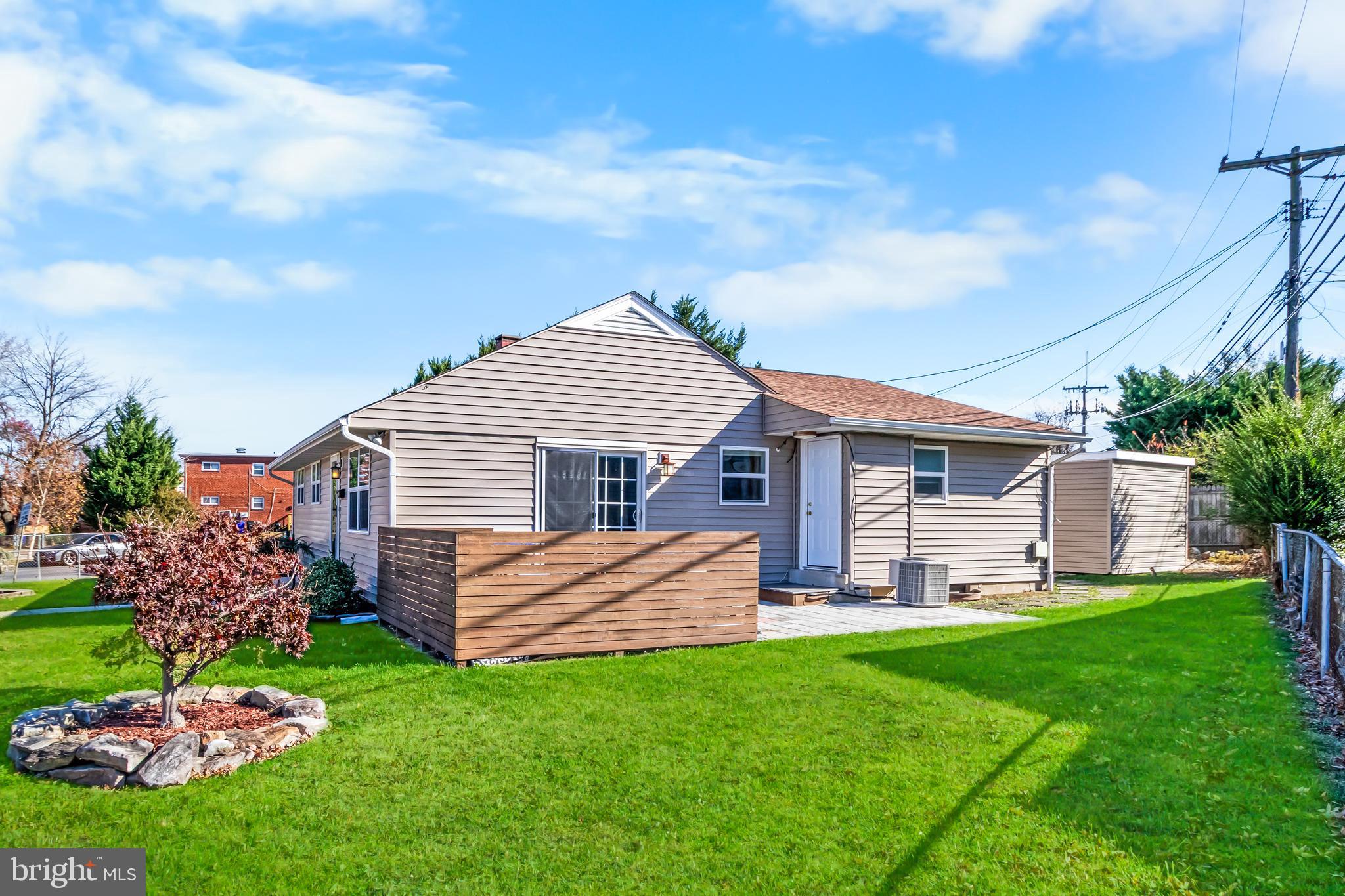 1000 8th Street Laurel, MD 20707 - Photo 28 of 45 a front view of a house with a garden and yard