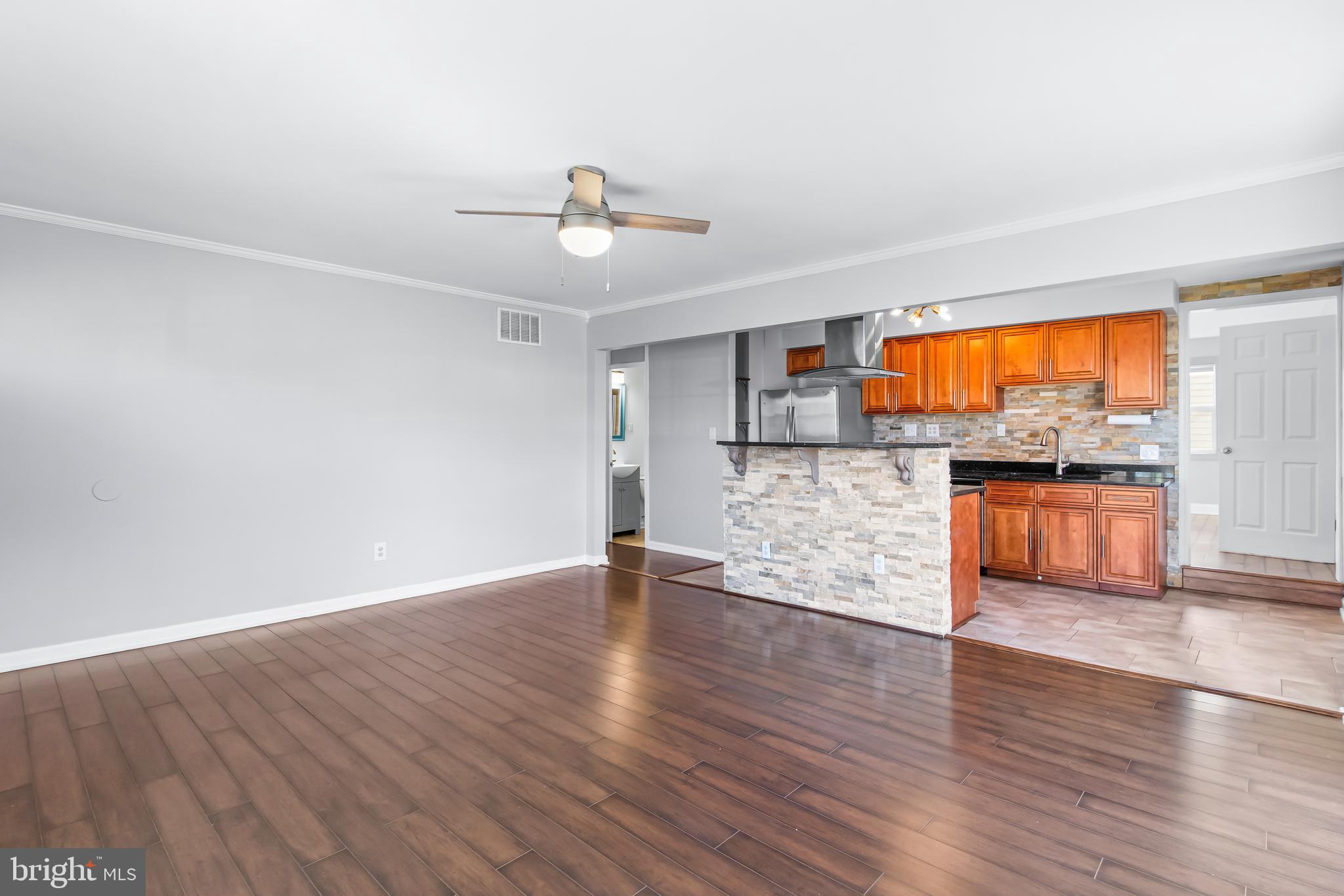 1000 8th Street Laurel, MD 20707 - Photo 4 of 45 a view of a kitchen with wooden floor and a kitchen space