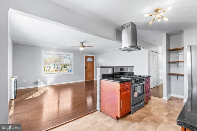 a kitchen with stainless steel appliances granite countertop a stove and a refrigerator